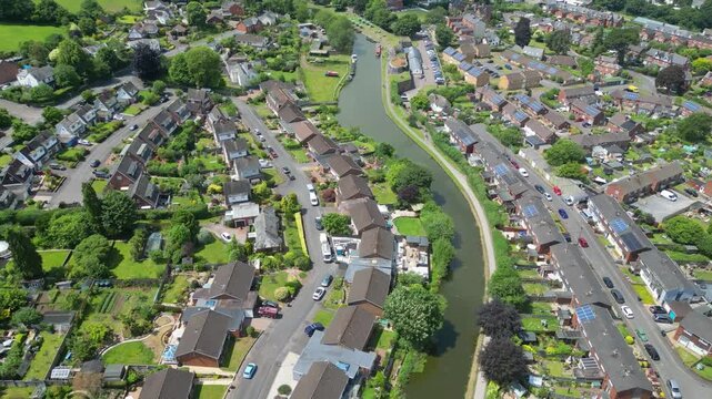Tiverton, Devon, England: DRONE VIEWS: The Grand Western Canal winds its way through suburban housing. Tiverton is the commercial and administrative centre of mid-Devon (Clip 1 of 5).