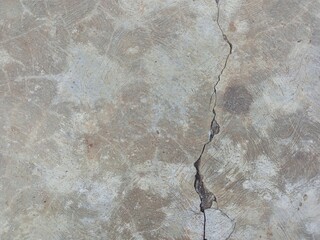 Long vertical crack in gray concrete floor texture
