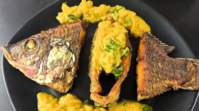 Deep-fried tilapia fish with pumpkin sauce, indoor Chiangmai Thailand.