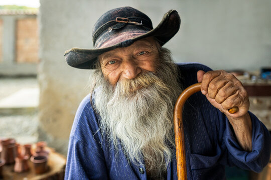 Elderly romani man smiling, creating a portrait portraying wisdom, experience, and traditional lifestyle - Powered by Adobe