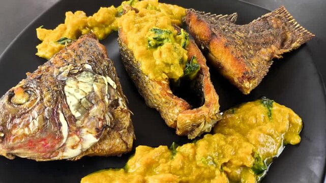 Deep-fried tilapia fish with pumpkin sauce, indoor Chiangmai Thailand.
