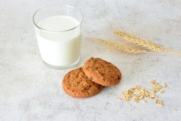 Wholesome Oatmeal Cookies and Milk with Grains on a Textured Surface