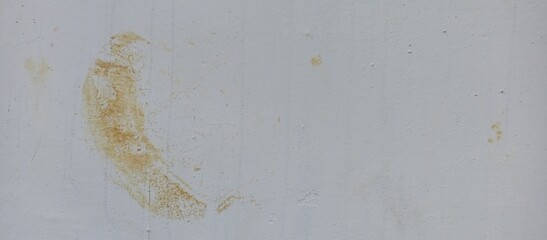 Subtle White Wall with Circular Brown Rust Stain