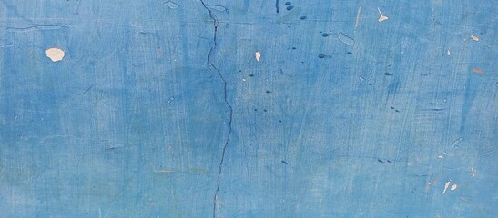 Vertical Crack on Rough Bright Blue Grunge Wall
