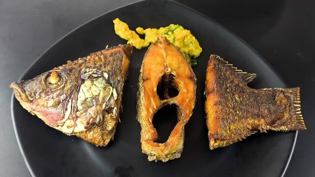Deep-fried tilapia fish with pumpkin sauce, indoor Chiangmai Thailand.