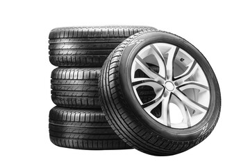 Four summer tires mounted on alloy wheels are neatly stacked, showcasing their design and tread....