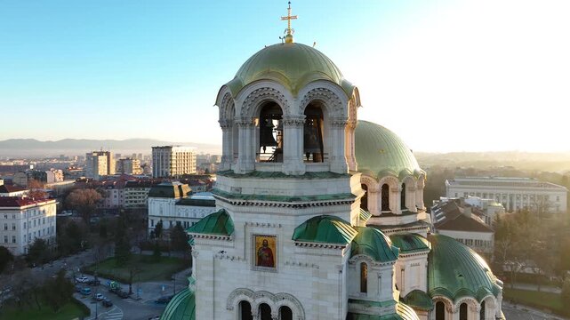 Аerial view of the capital of Bulgaria - Sofia. Iconic building. Close-up and backlight view of the St. Alexander Nevsky Cathedral at sunrise or sunset. The largest church in the Balkans. Movement.