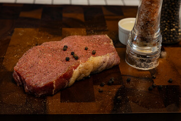 Fresh Raw Beef Steak With Rub On The Wood Board