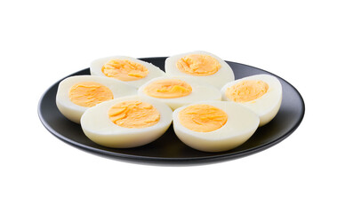 A black plate with halved boiled chicken eggs isolated on a white background.