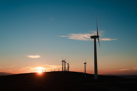 Wind turbines at sunset over hills, Spain