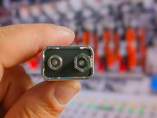 Close-up of a man's hand holding a battery