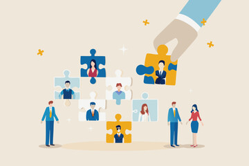 Hand placing a puzzle piece with a businessman into a team of diverse professionals represented by puzzle pieces