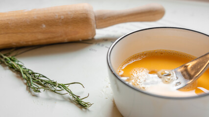 Baking Ingredients on Kitchen Counter, Eggs, Rolling Pin, and Rosemary