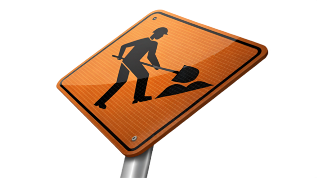 An orange road sign depicting a construction worker digging with a shovel on a black background
