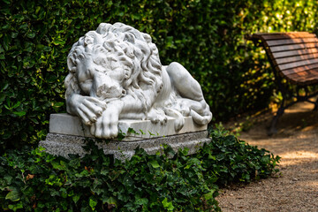 Fototapeta premium Sleeping Marble Lion Statue in Historic European Garden Santa Clotilde, Lloret de Mar, Spain