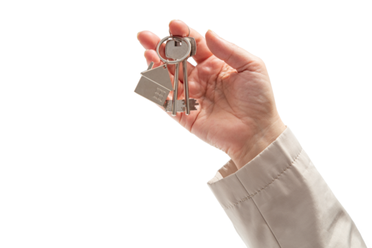 Woman's hand holding keys on isolated background. Concept of sale of real estate, rent of housing