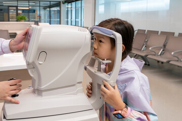 The little girl has her vision checked in the hospital