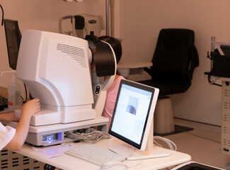 The little girl has her vision checked in the hospital