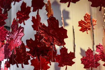 Decorative, red, hanging maple leaf ornaments. The maple leaf is a symbol of Canadian national identity.