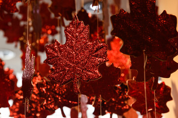 Decorative, red, hanging maple leaf ornaments. The maple leaf is a symbol of Canadian national identity.