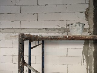 construction autoclaved aerated concrete wall with rusted scaffold