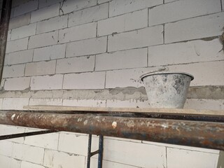 construction autoclaved aerated concrete wall with rusted scaffold