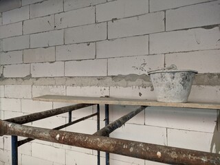 construction autoclaved aerated concrete wall with rusted scaffold
