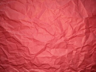textured paper background , wrinkled reddish surface