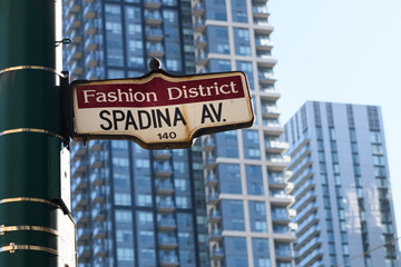 Rusted and bent Spadina Avenue street sign in the fashion district of downtown Toronto, Ontario, Canada.