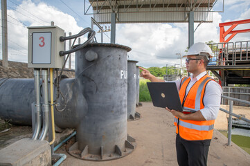 engineer is inspecting the area around the water control plant and inspecting the water storage tank