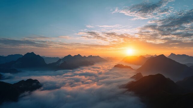 Majestic mountain peaks emerge from a sea of clouds at sunrise with golden sunbeams breaking through