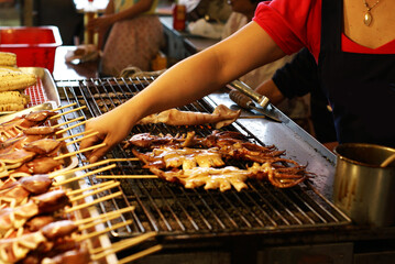 Delicious grilled squids. Taiwanese street food at Taiwanese night markets or Seafood markets. 
