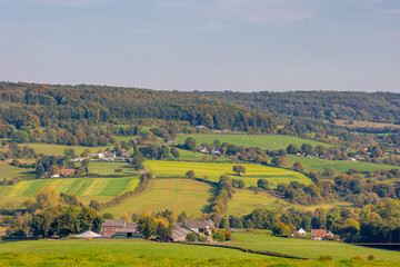 Fototapeta premium Autumn landscape, Terrain hilly countryside in Zuid-Limburg with small houses hidden on hillside, farmland and forest, Epen is a village in southern part of the Dutch province of Limburg, Netherlands.