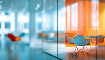 Modern office with glass walls, colorful chairs, and a meeting table