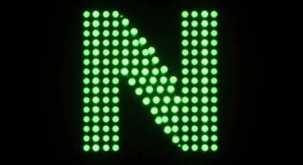 Bright green led letter n illuminated against a dark background