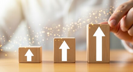 Hand arranging wooden blocks with arrow pointing upwards representing growth