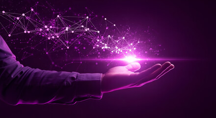 Bright pink light radiating particles over a person's hand, representing the creation of data, the emergence of innovative ideas, and the advancement of digital technology on a purple background.
