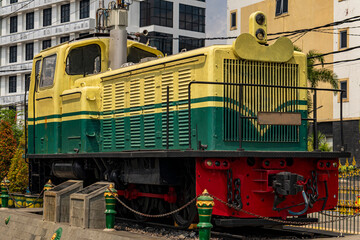 Vintage Green and Yellow Diesel Locomotive Displayed Outdoors with Industrial Design