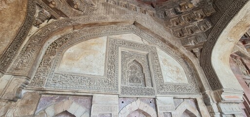 Intricately Carved Stucco Ceiling and Arches of Bada Gumbad Mosque in Delhi Showcasing Islamic Geometric Patterns and Calligraphic Art