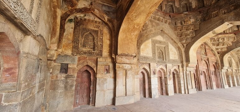 Intricately Carved Stucco Ceiling and Arches of Bada Gumbad Mosque in Delhi Showcasing Islamic Geometric Patterns and Calligraphic Art