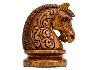 Close-up of a detailed carved wooden horse chess piece, isolated on black