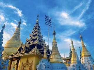 Naklejka premium Shwedagon Pagoda in Yangon Myanmar, Famous Golden Buddhist Temple Landmark with Blue Sky