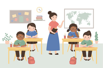 School lesson. Little students and teacher. Classroom interior with furniture. Multi ethnic students at desk. Classmates and mentor in classroom.