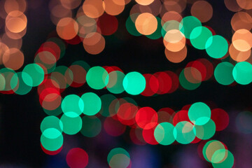 Colorful bokeh lights in a night city scene create a festive, dreamy mood