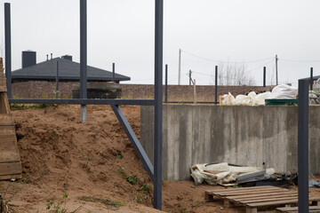 Installation of a fence around the house. Posts made of iron.