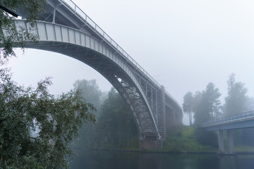 Fototapeta premium Historic Heinola railway bridge on a misty morning.