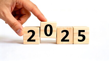 Hand changing wooden blocks to 2025