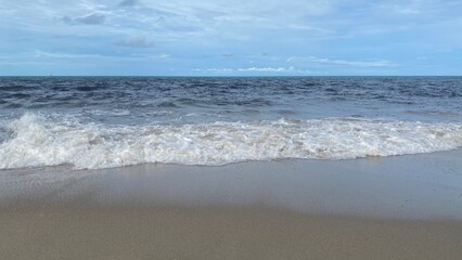 Sea Wave Crashing on Sandy Beach
