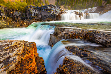 Vibrant View of Kootenai Falls Through Golden Sunlight