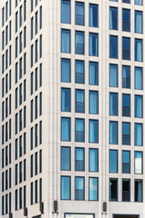 Fototapeta premium View of modern concrete glass metal high rise building facade exterior at day light time in Berlin Mitte city urban street. Business financial corporate office futuristic architecture